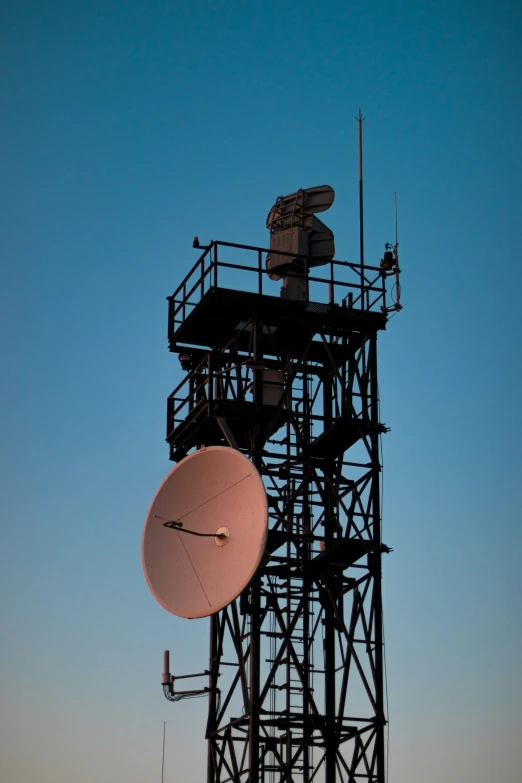 the radio tower is located on an early evening