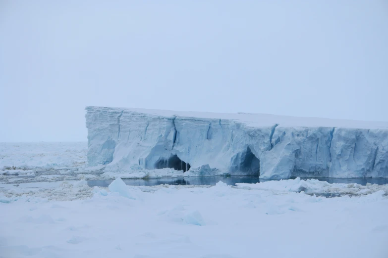 iceberg with a cave in it on the ice