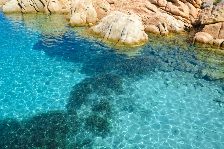 clear water in some blue water between two large rocks