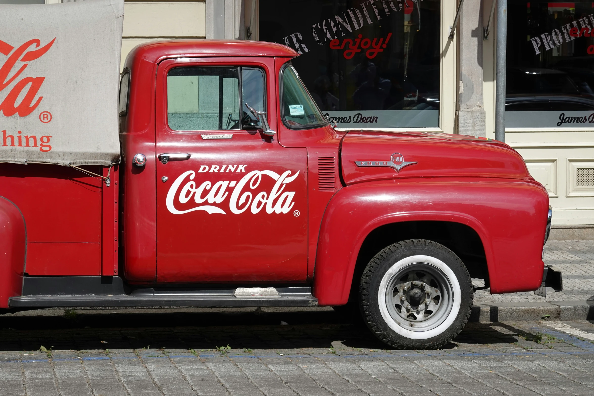 a red truck is parked on the side of a street