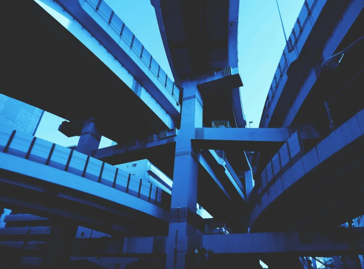 a bridge that has blue railings running up the side of it