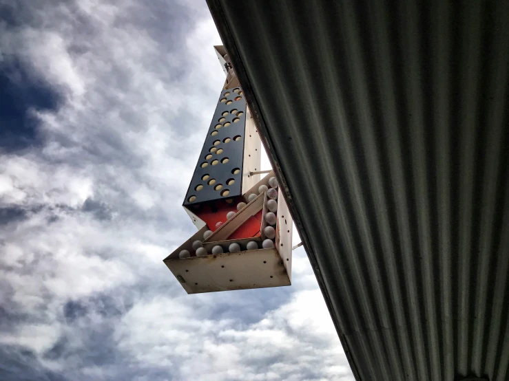 a traffic light on top of a structure against the sky