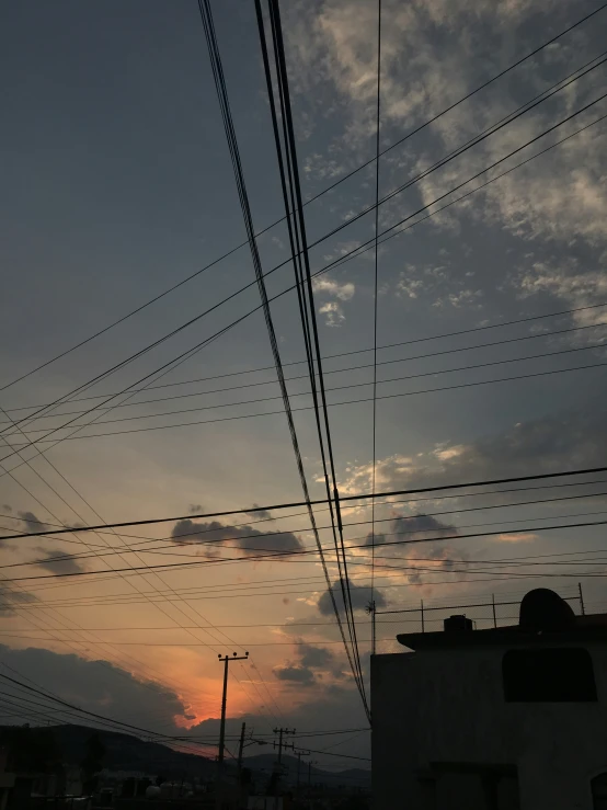 a dark blue sky with clouds and lines