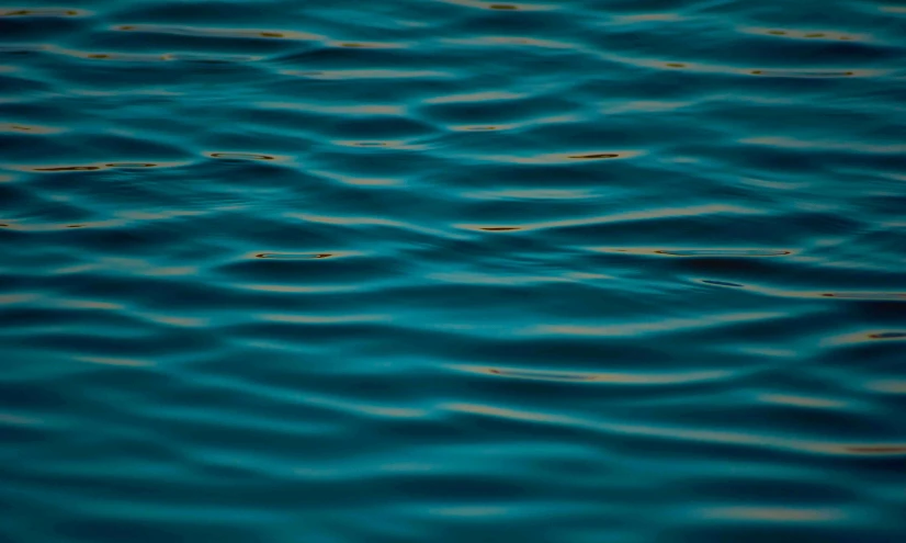 closeup of water and ripples that are blue and yellow