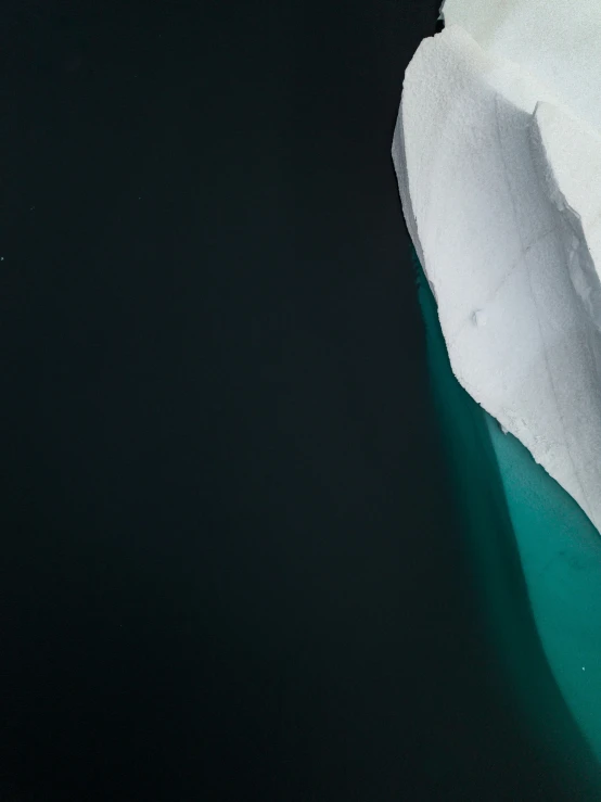 a small airplane that is flying over an iceberg