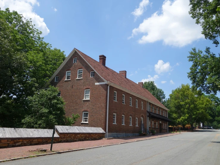 an old brick building sitting on the side of a road