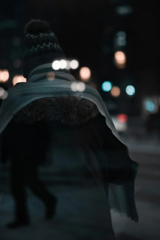 a person walking alone down the street at night