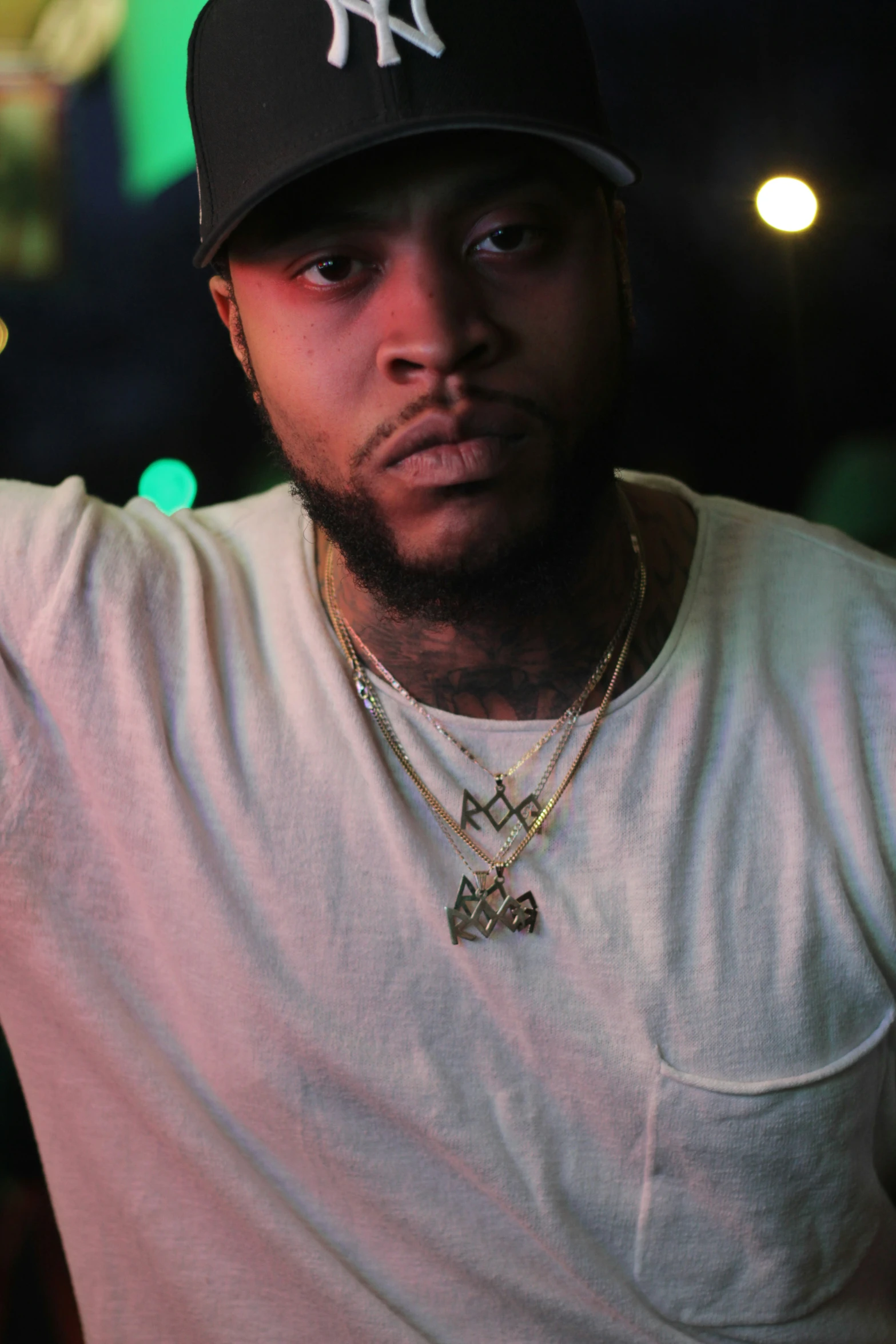 young black man wearing a yankees cap posing for a picture