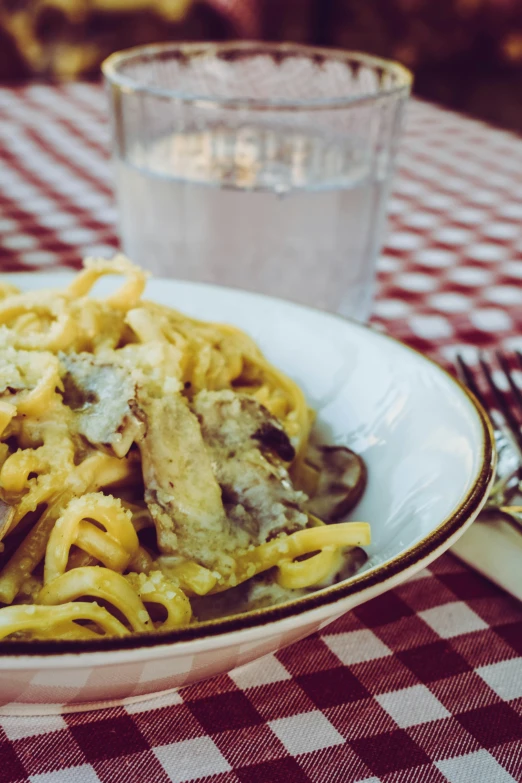 a bowl that has some pasta in it on a table