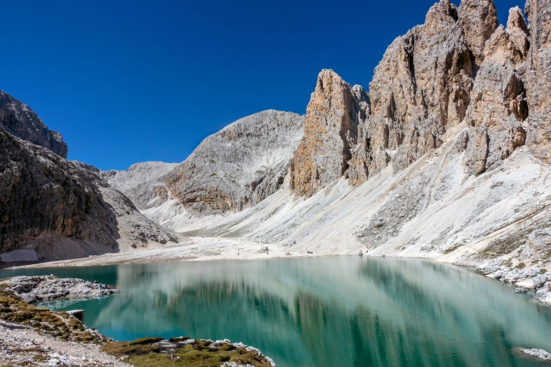 a big lake is near a mountain with snow