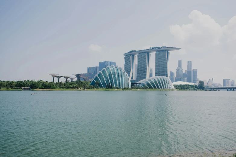 a very large body of water with some buildings in the background