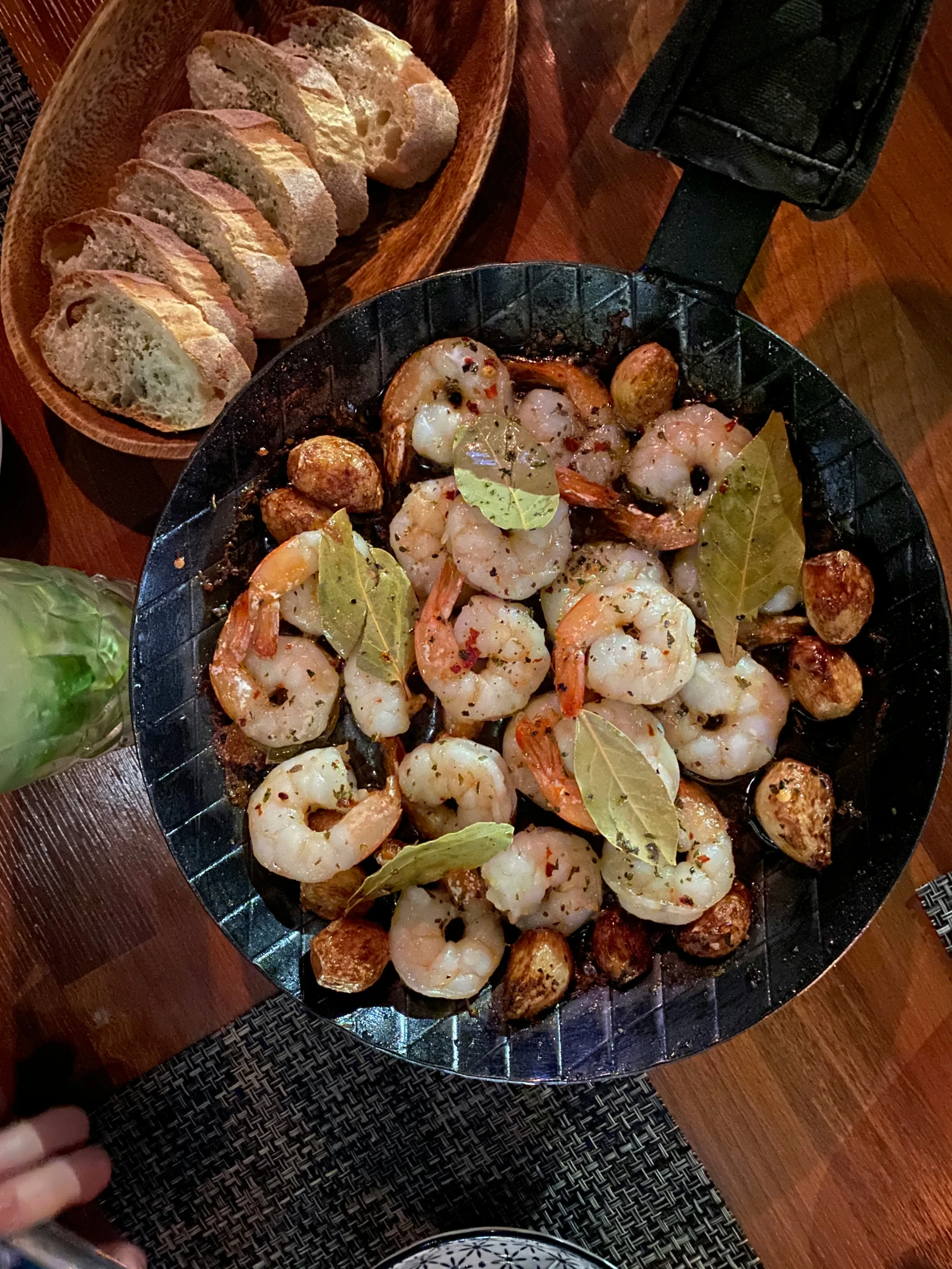 shrimp and scallops is being cooked with garlic bread