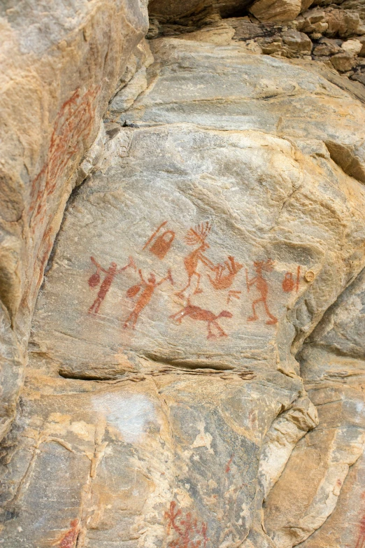 an ancient rock painting of horses on a cliff