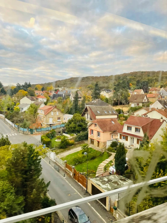 the view from a balcony shows houses and houses, street and mountains