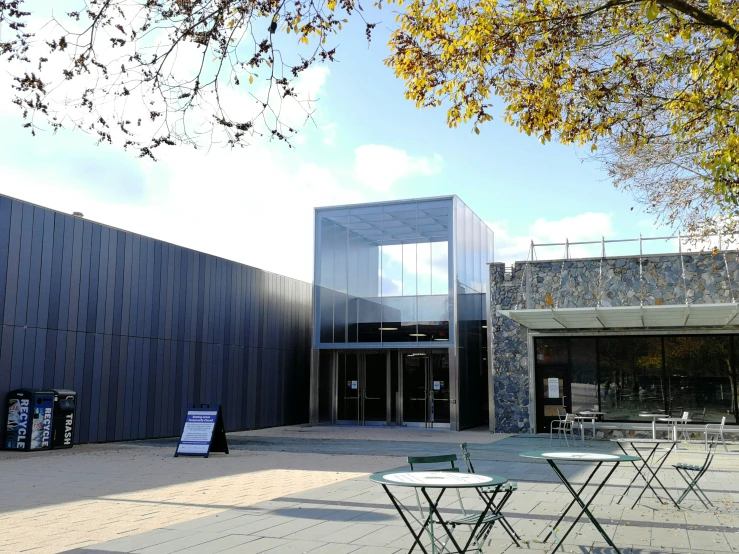 a group of tables and chairs next to a building