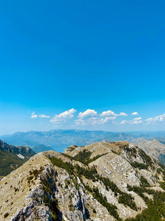 a person sitting on top of a mountain