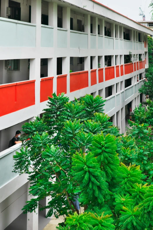 a man in a large building with red and white paint