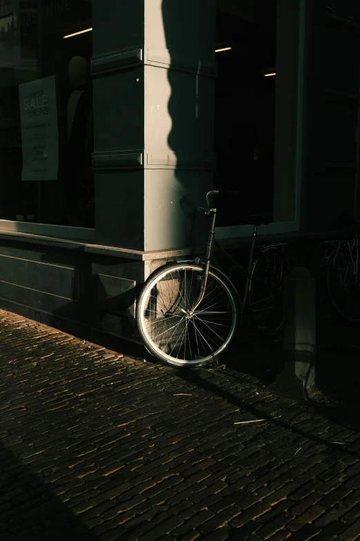 a bicycle parked next to a building at night