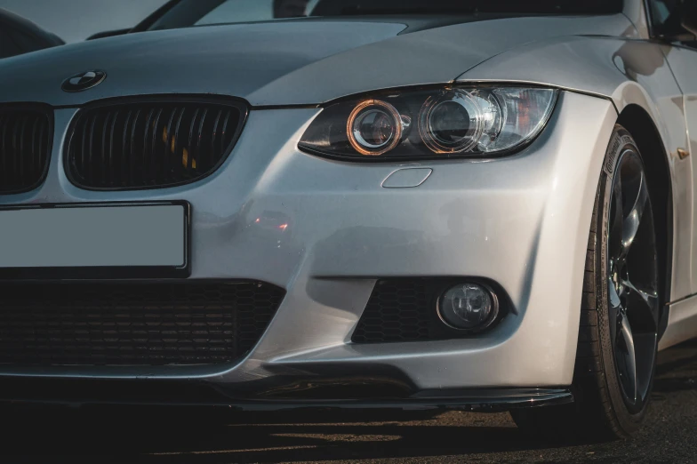 the front end of a silver car is shown