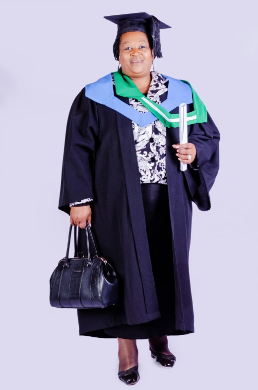 a person in graduation cap and gown holding a bag and a hat
