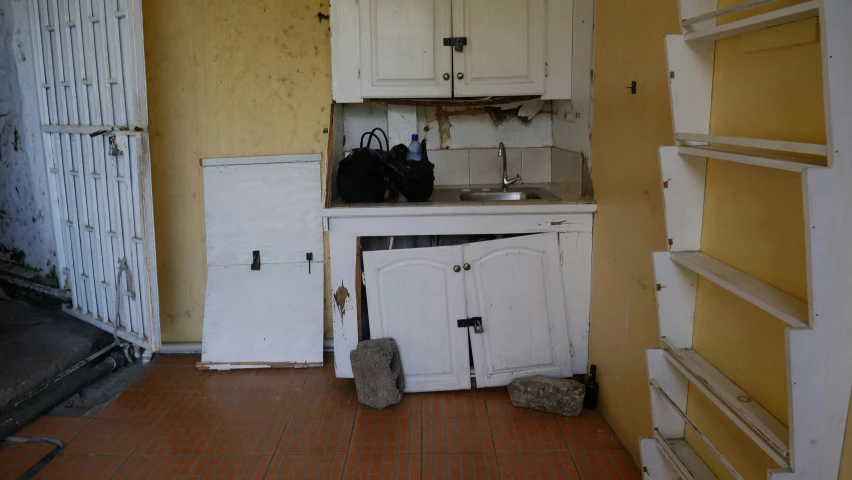 the kitchen is full of dirty appliances and cupboards