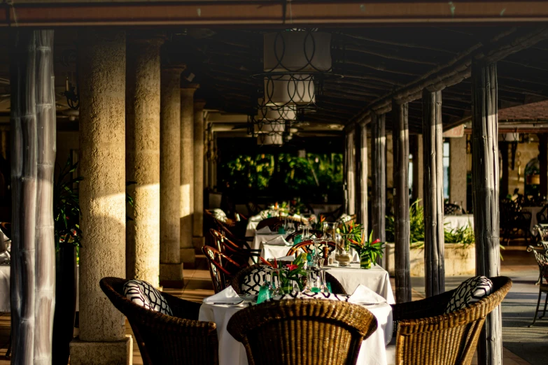 an outdoor restaurant setting in the shade of some lamps
