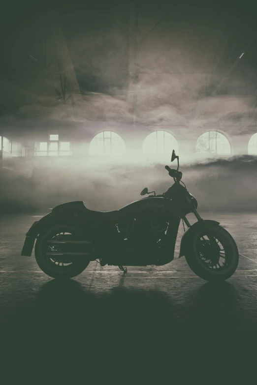 a black and white po of a motorcycle in front of a light