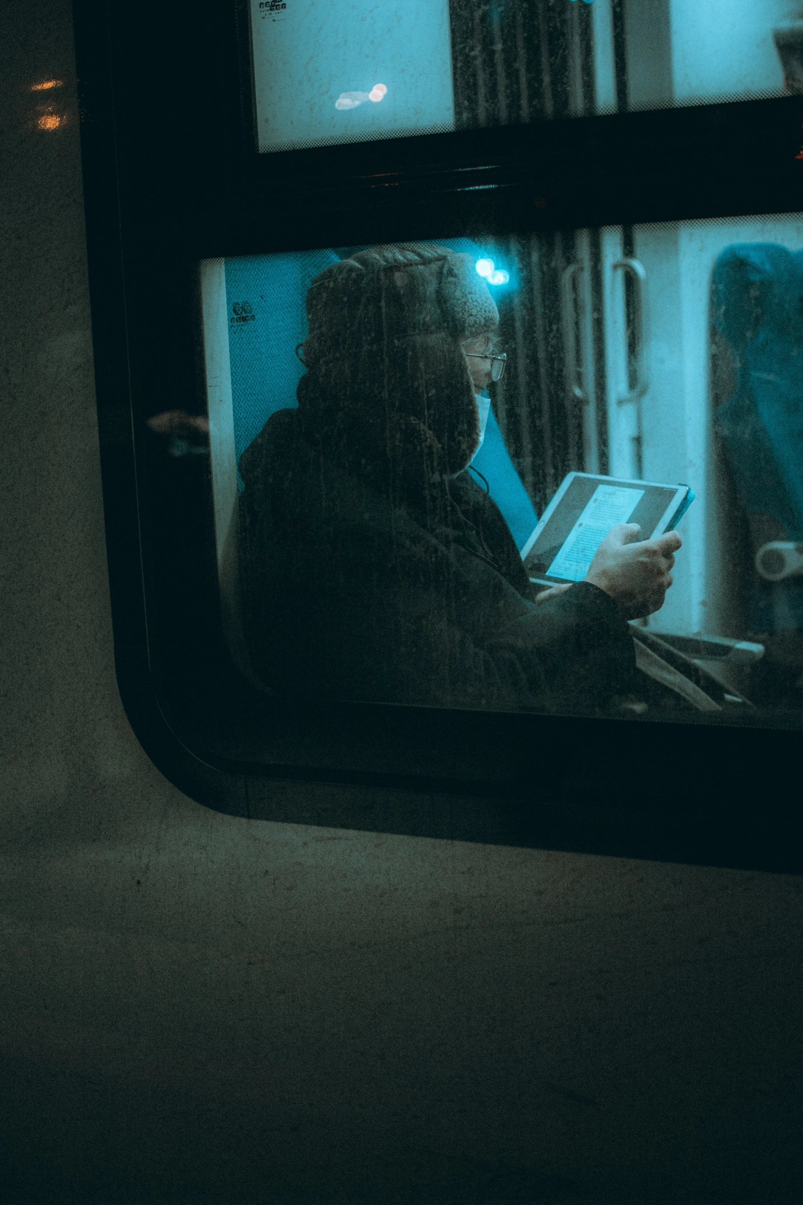 a woman in a dark coat on a train