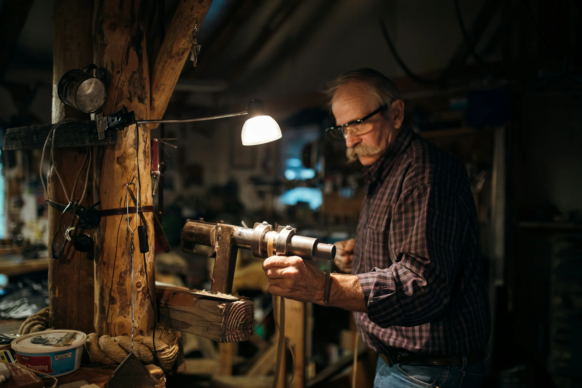 an old man working on his projects with an old style object