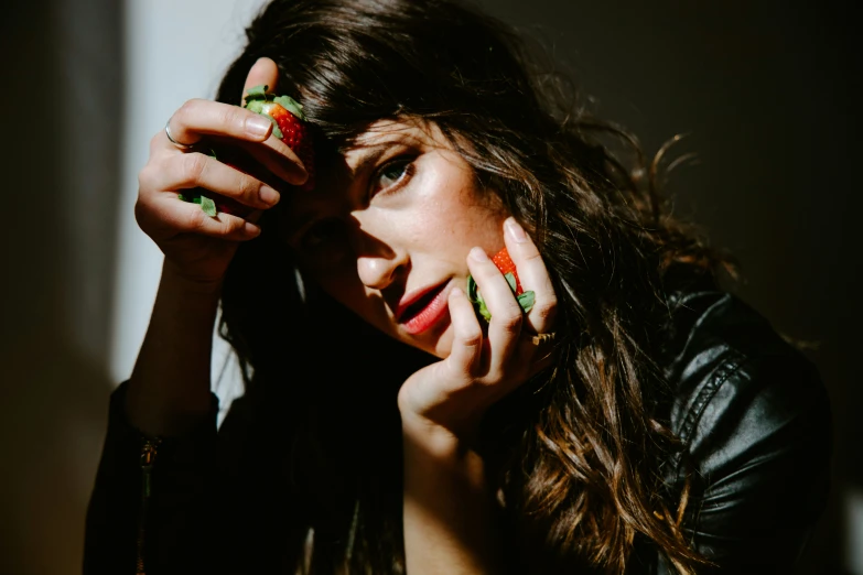 a close up of a woman with her hand on her face