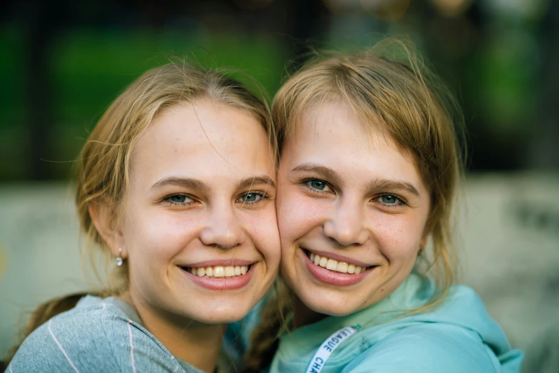 two pretty young ladies smiling for a picture