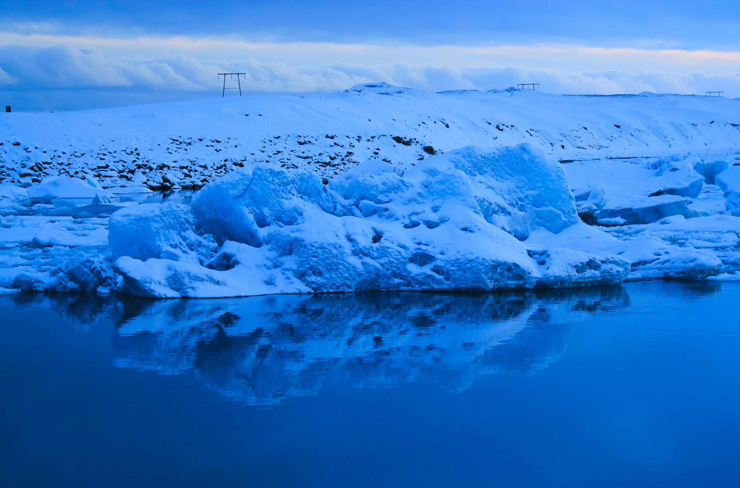 a small patch of snow sitting in the middle of a lake