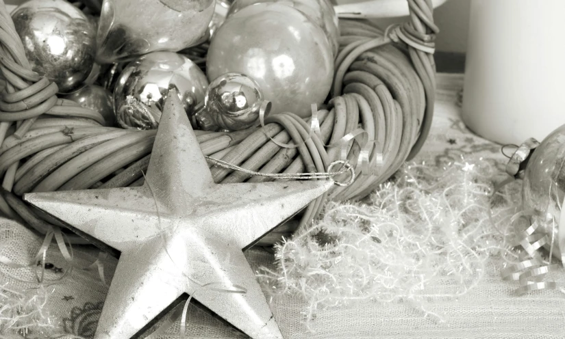 a star sits on a table beside some christmas decorations