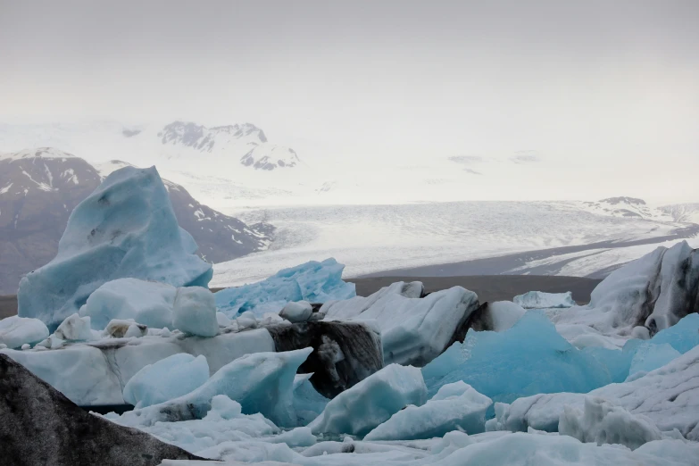 large chunks of ice that are sitting on some rocks