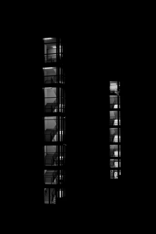 three windows, each open to reveal a building with shelves in it