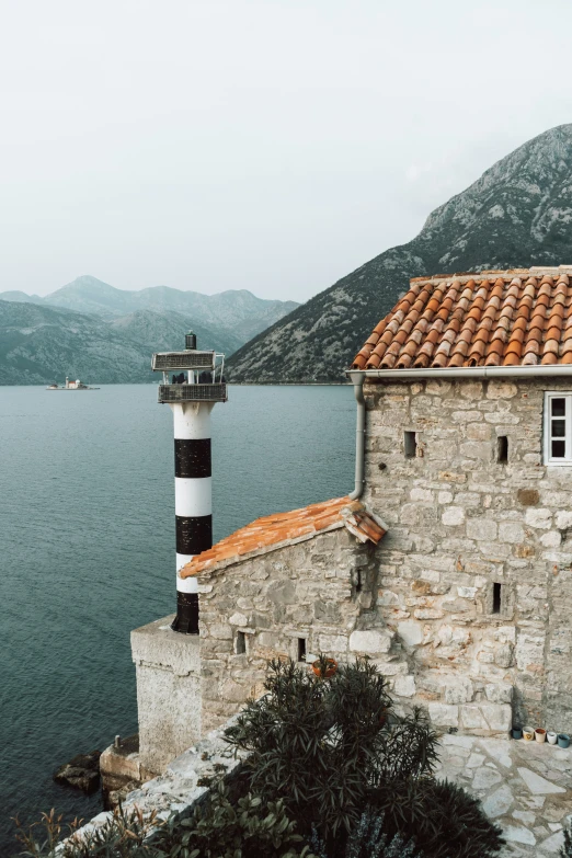 two lighthouses sitting on top of a building by a lake