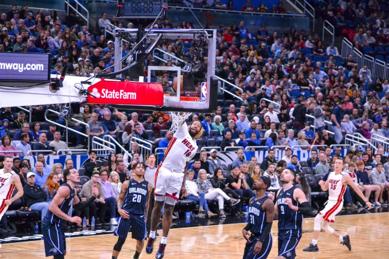 men playing a game of basketball with fans watching