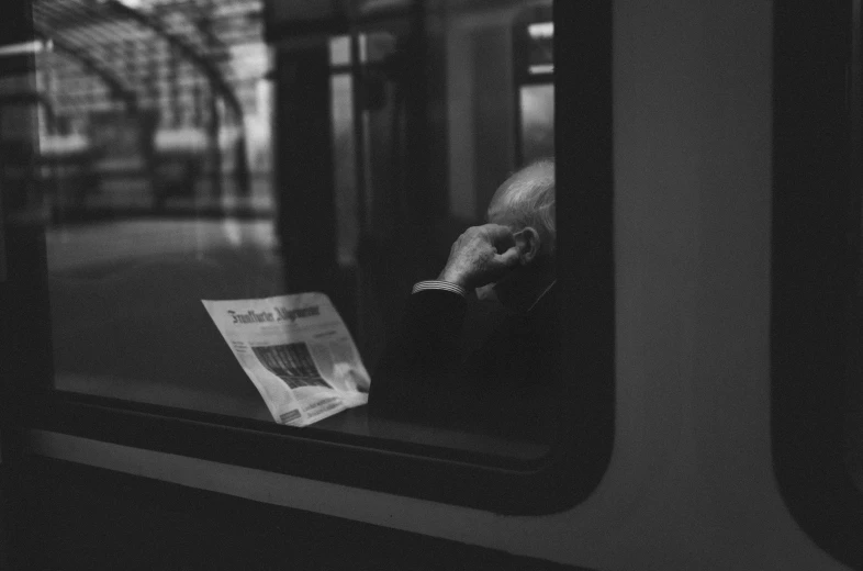 the reflection of a hand sticking out of a window