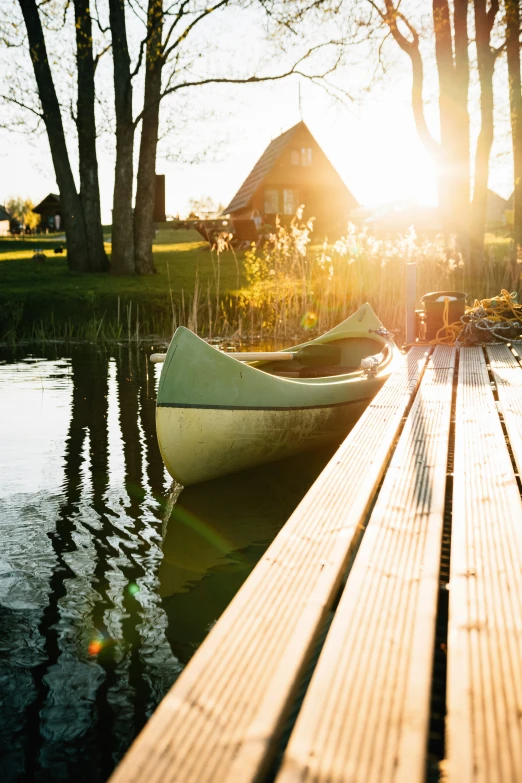 a boat is on a wooden pier at dusk