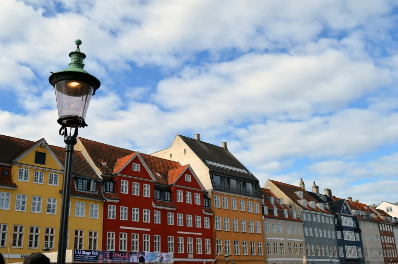 some very pretty buildings with a street lamp on the side