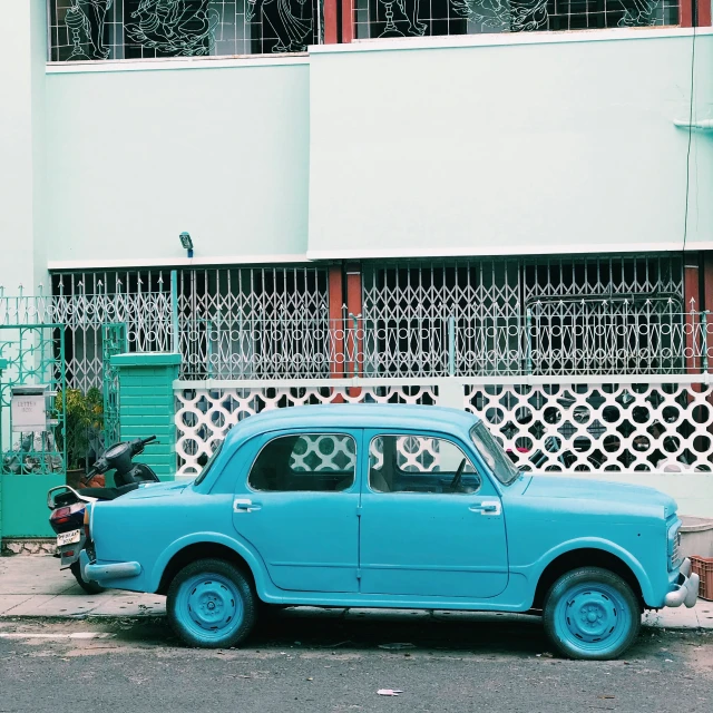 a very nice looking car parked in front of a building