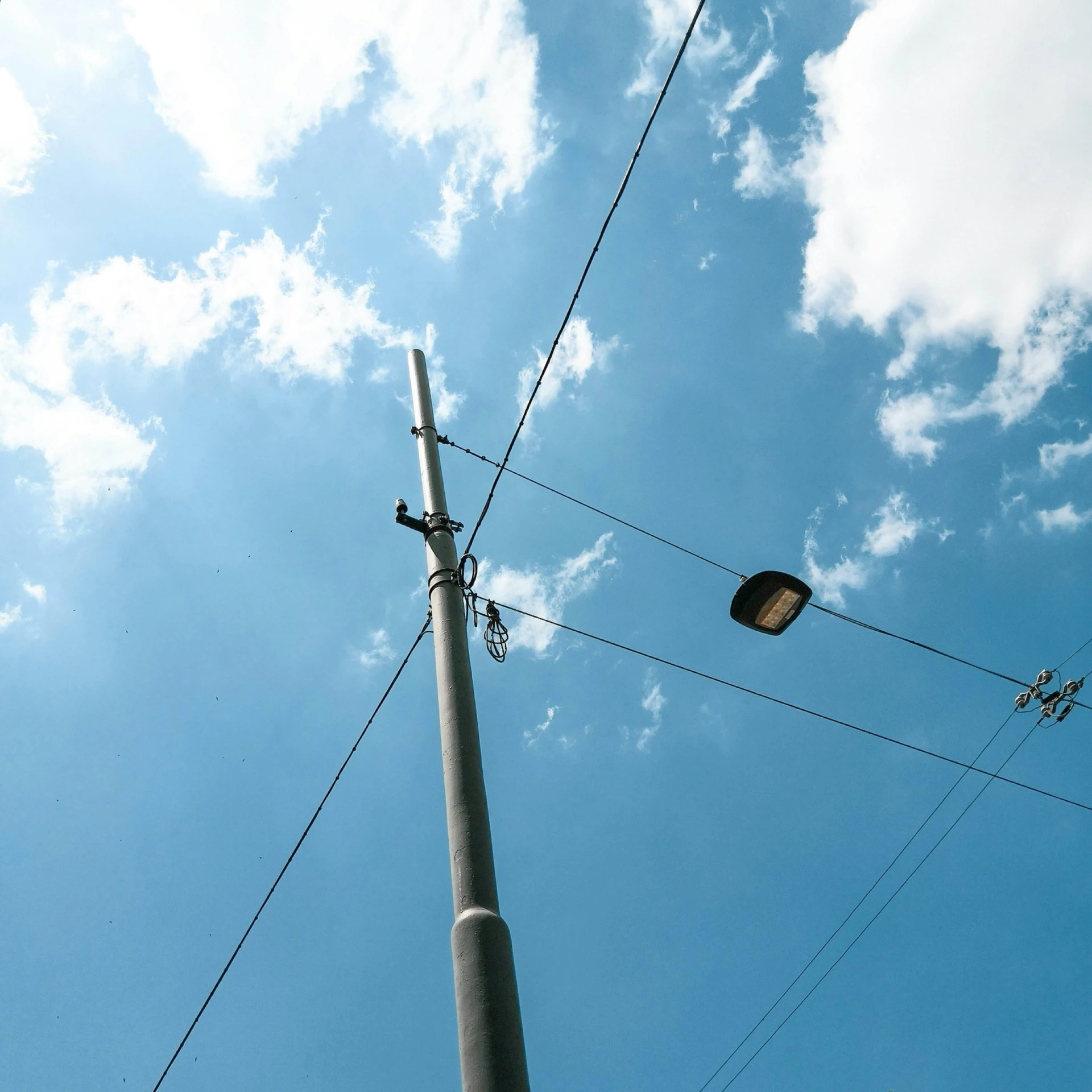 a street light and telephone pole with wires connecting them