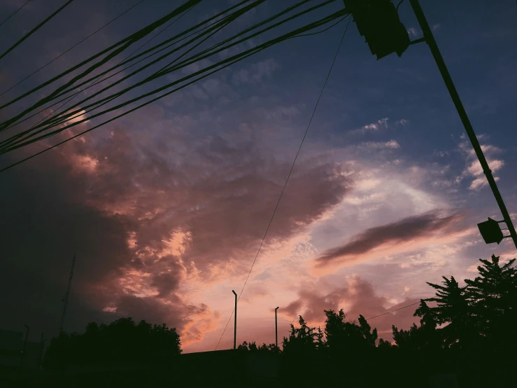 this is an outdoor setting with the sun setting and the sky looking pink