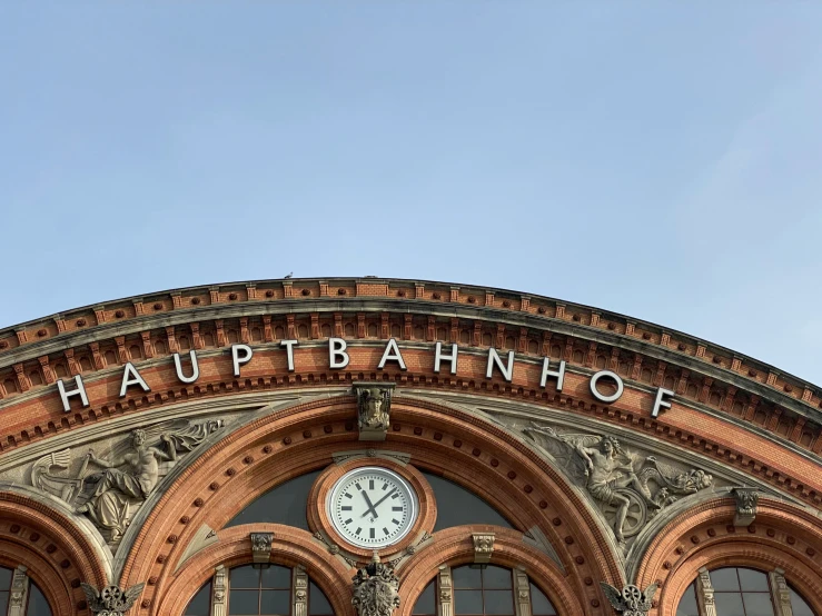 an upward view of a building with a clock on it