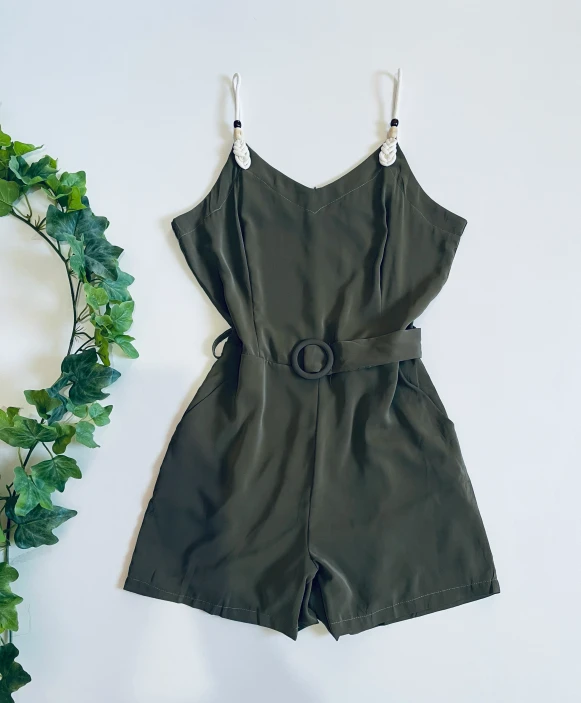 short romper in green suede on a white background
