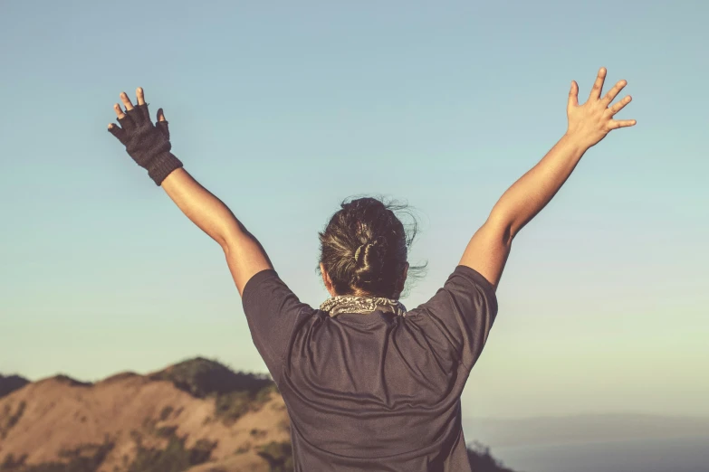 a woman is standing with her hands up in the air