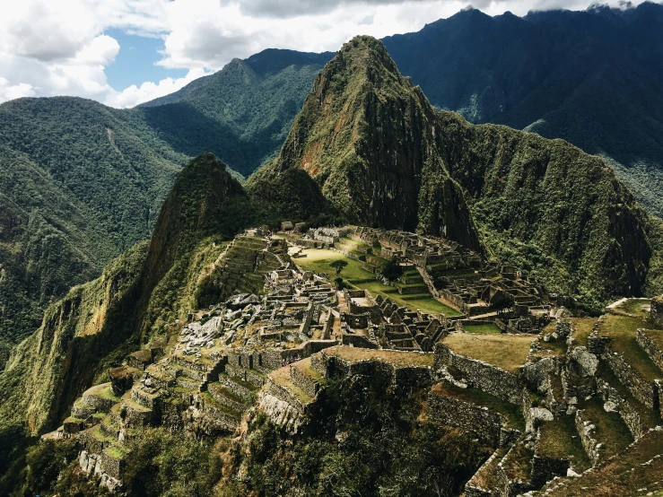 a mountain landscape is shown with a village on the top