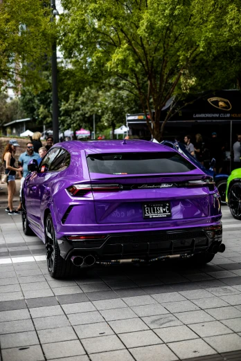 the purple car is parked on the side of the street