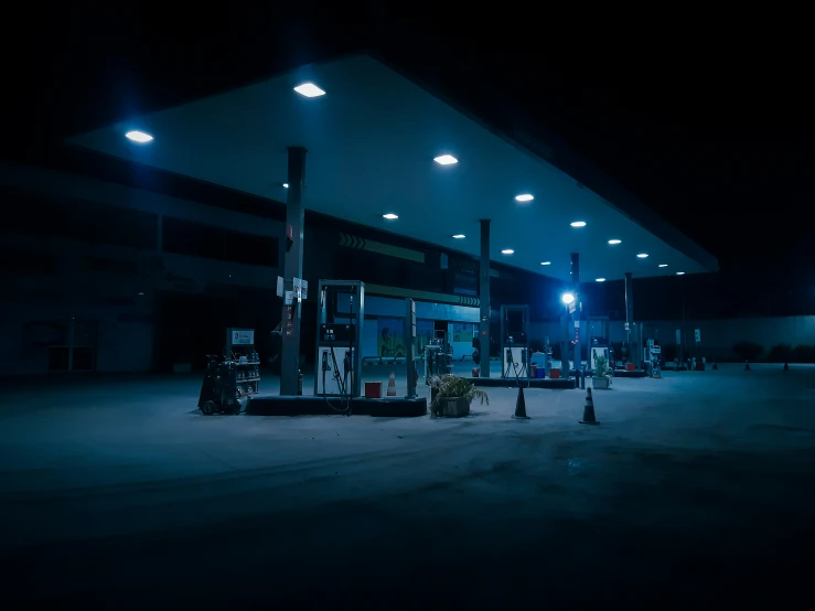 a gas station with empty lights and lots of gas pumps