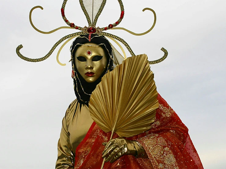 this costume features gold wings and black mask with feathers on its head